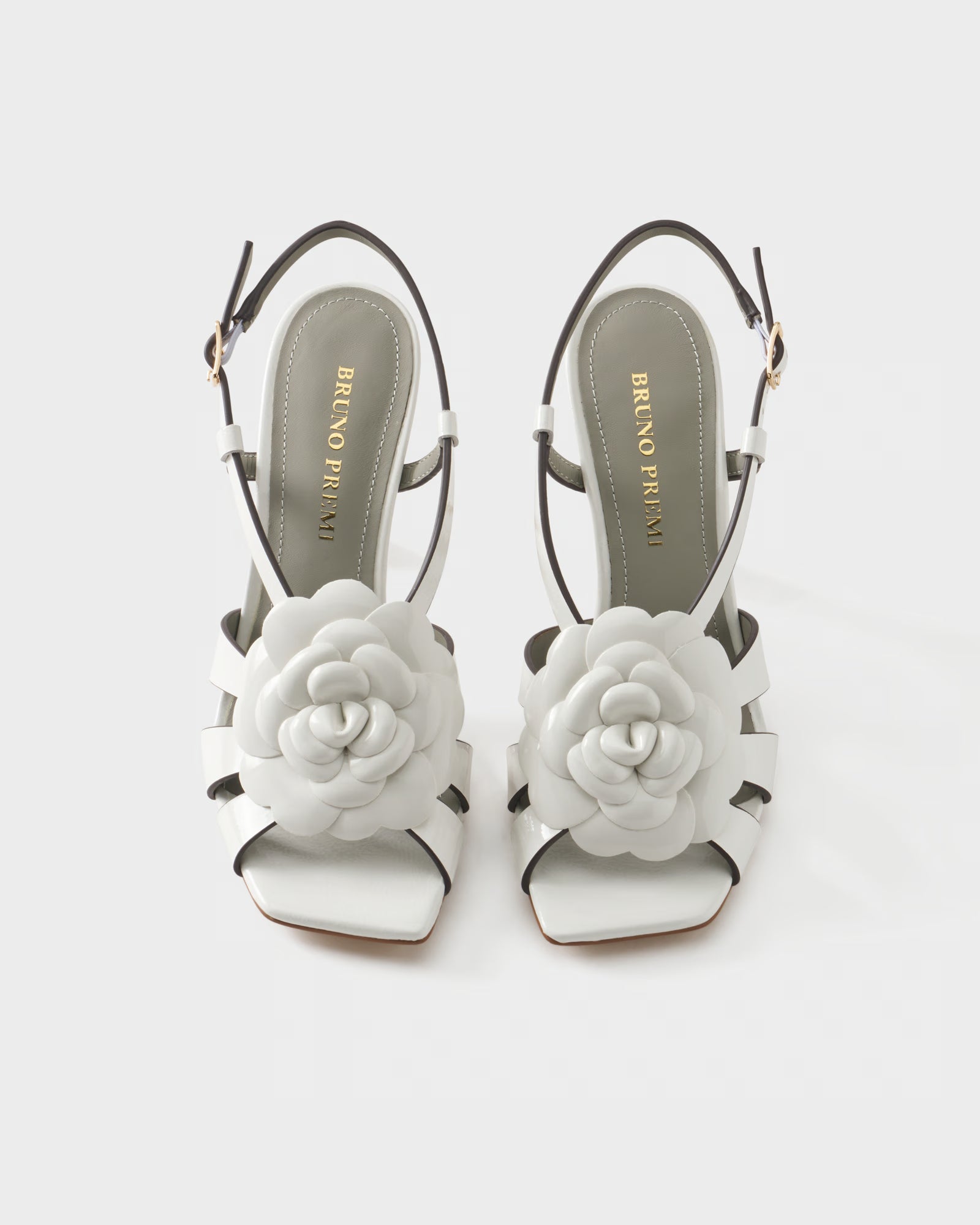 Slingback sandal in patent leather with floral embellishment